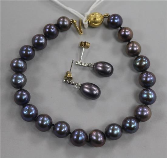 A pair of white metal Tahitian cultured pearl and diamond set drop ear studs and a similar bracelet with gold plated clasp.